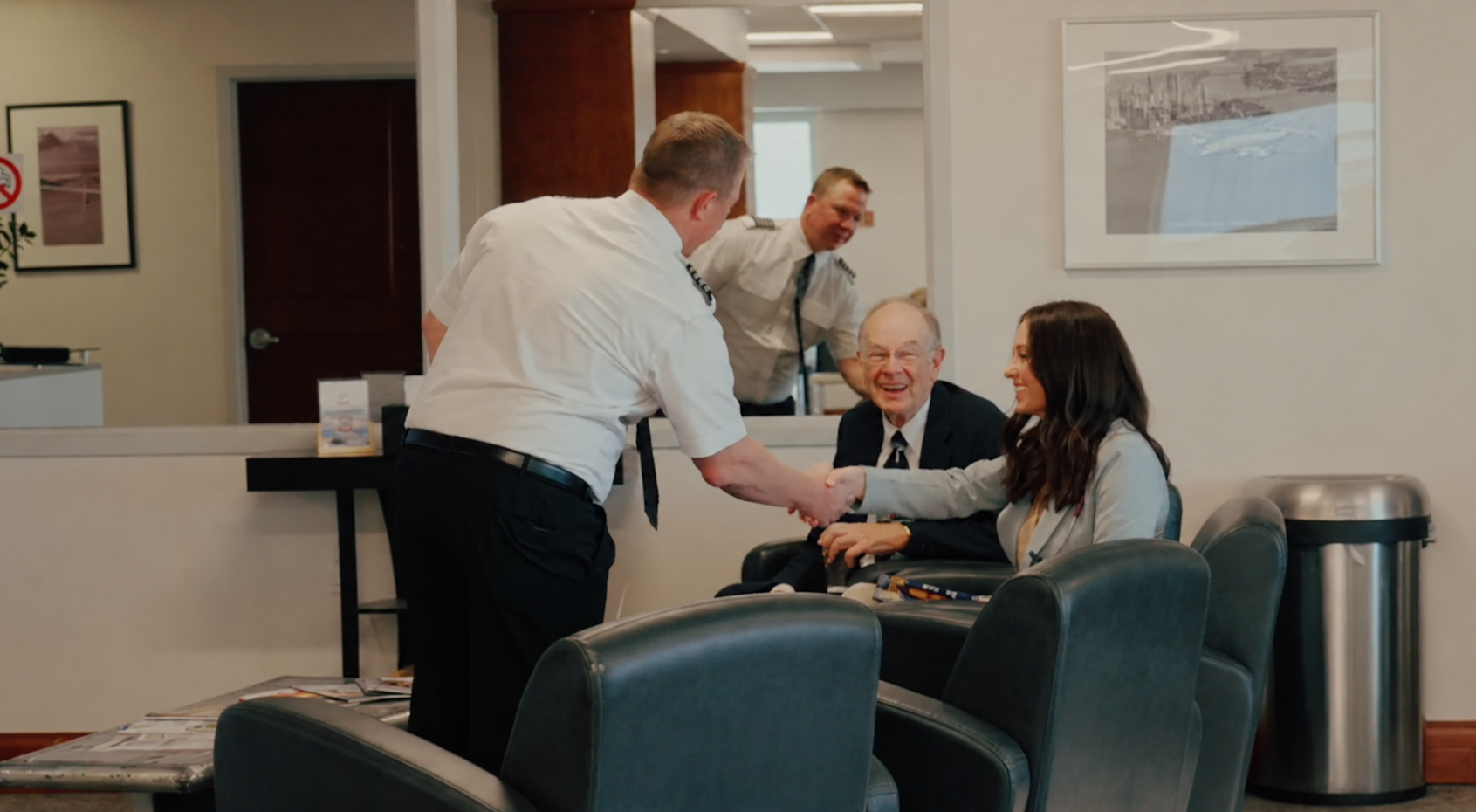 Skyroads pilots greeting passengers in the lounge before departure