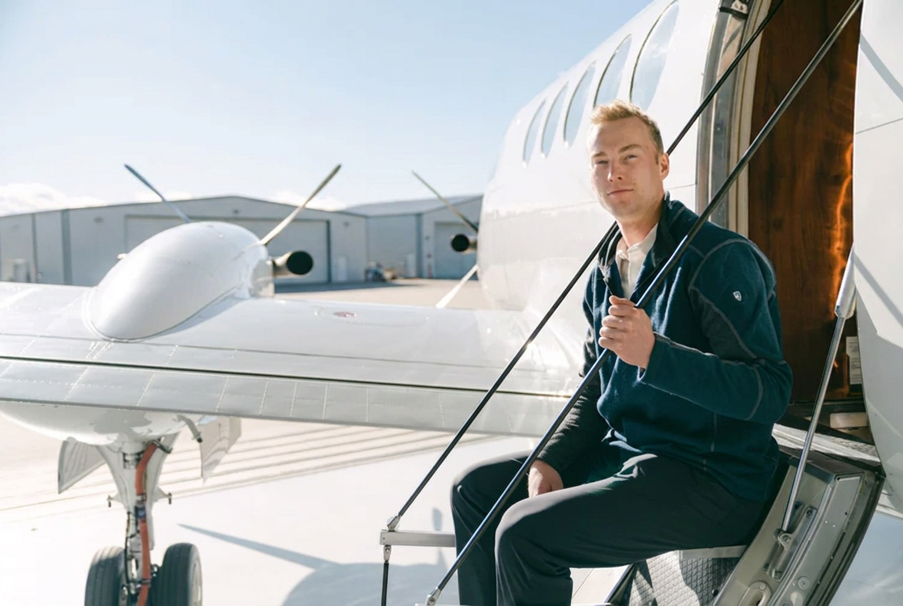 Skyroads captain stepping aboard a single-engine turboprop aircraft on the ramp